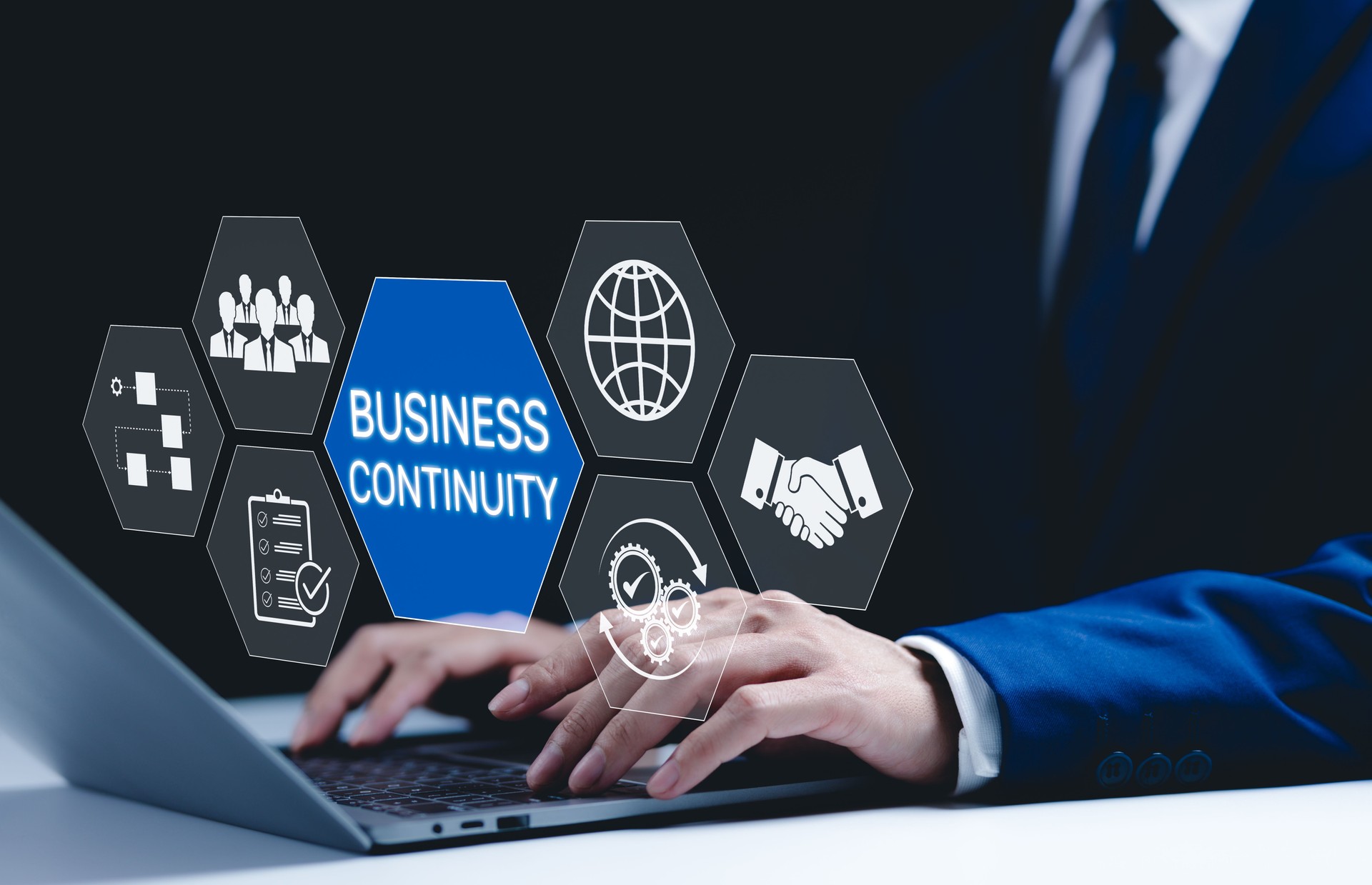 Business continuity and strategy concept. Businessman use laptop with digital icons represent business continuity, global operations, teamwork, workflow, and strategic planning in diverse conditions.